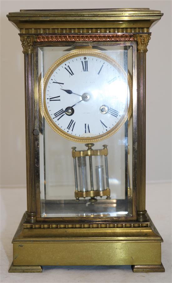 An Edwardian brass four glass mantel clock, 11in.